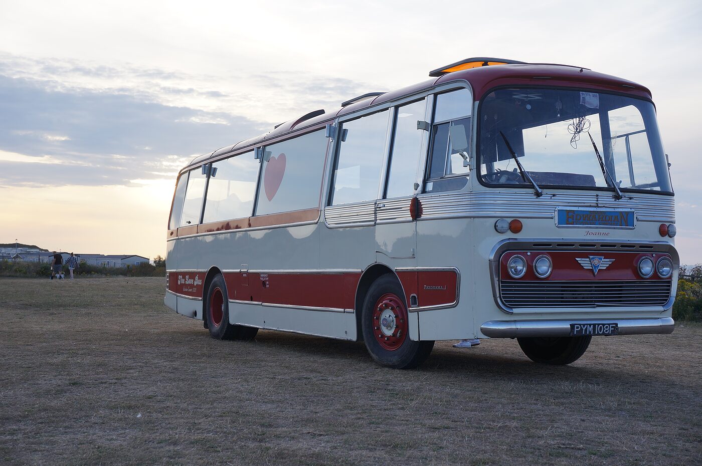 The Love Bus under a dramatic evening sky