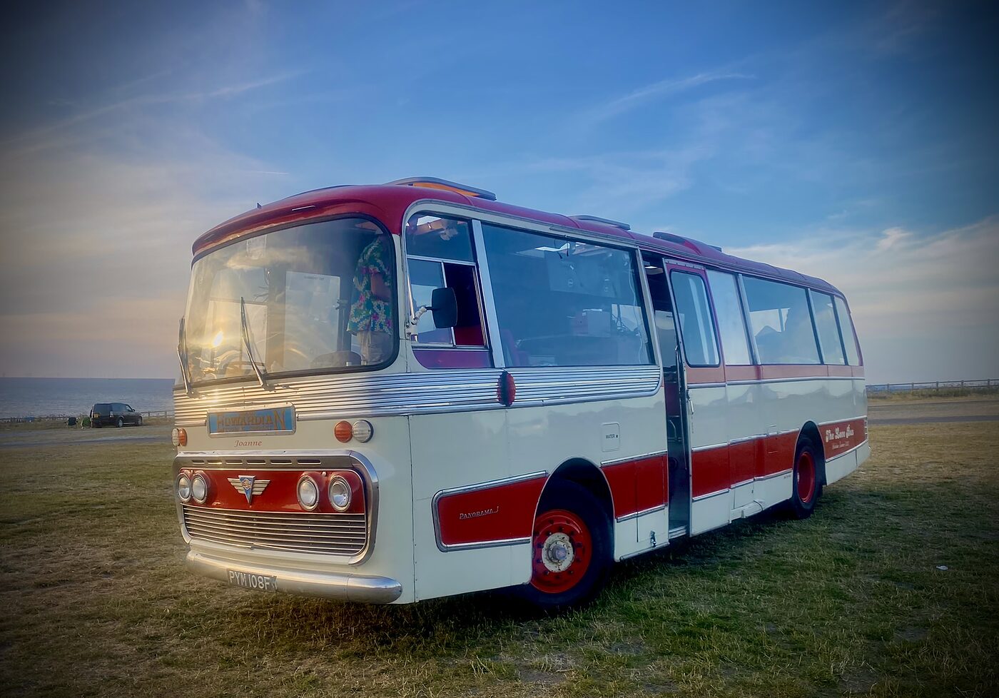 The Love Bus at dusk on a festival site