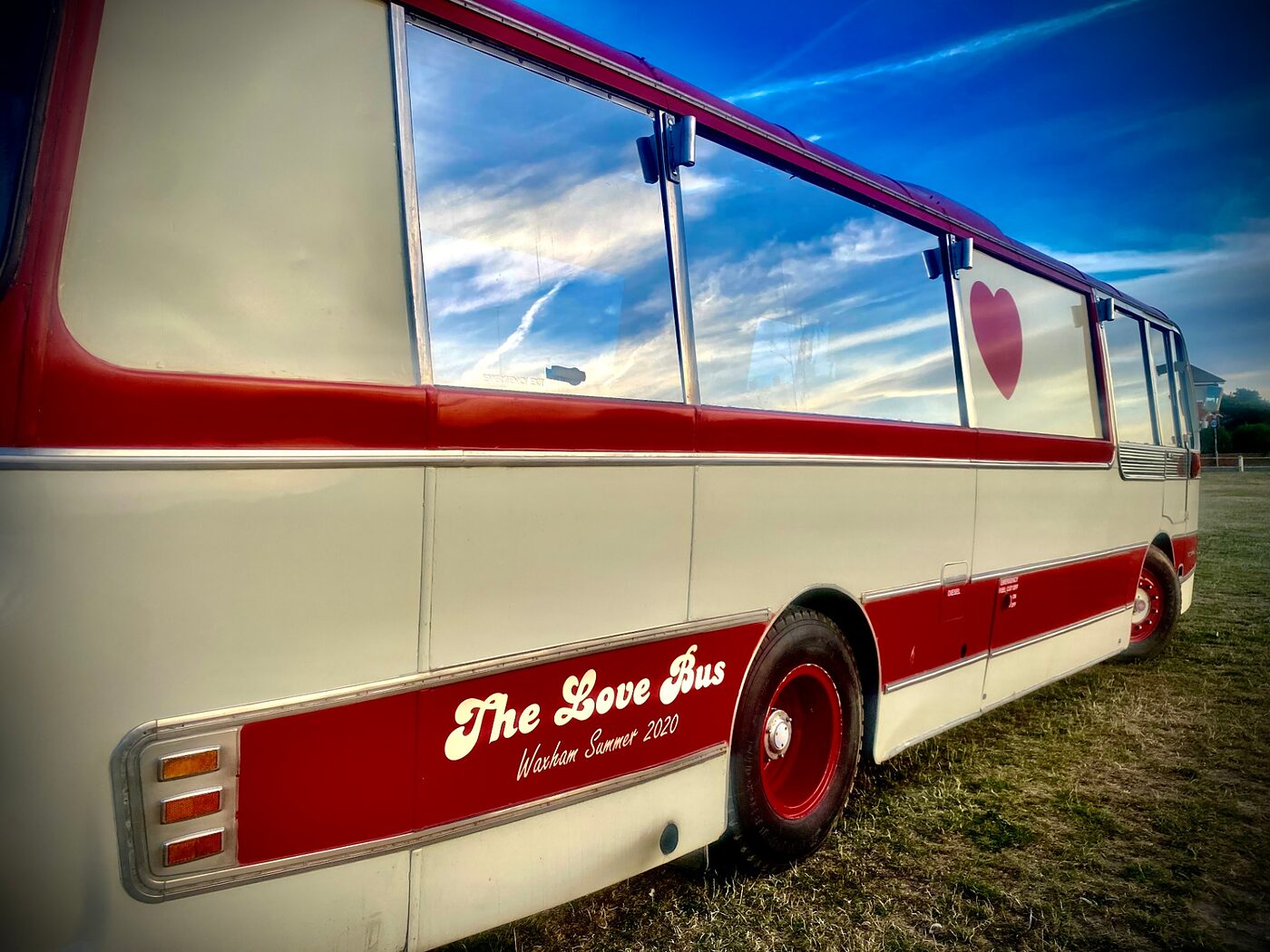 The Love Bus parked in a field at a festival
