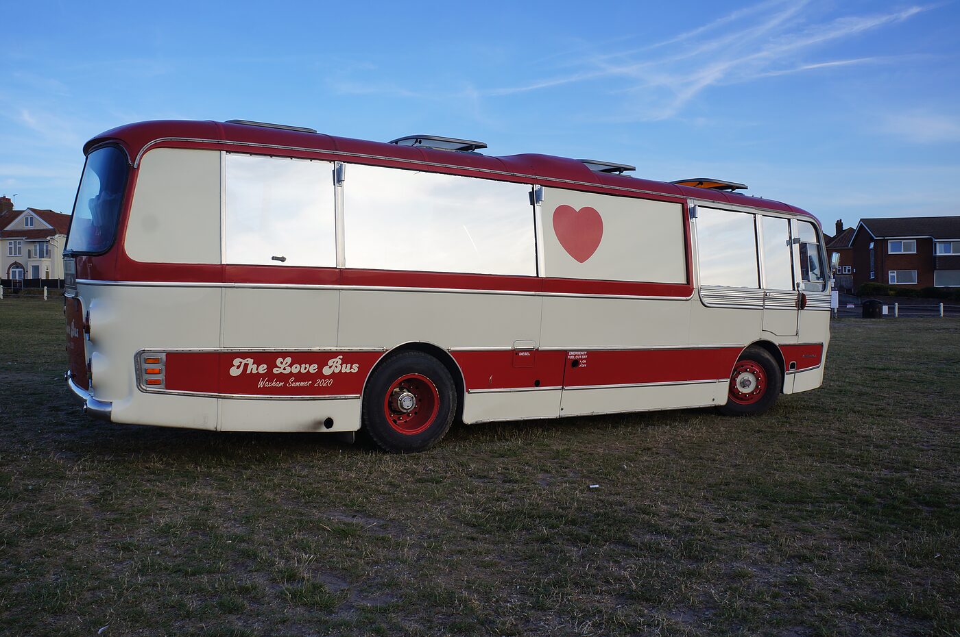 Full side view of The Love Bus showing the heart and signwriting