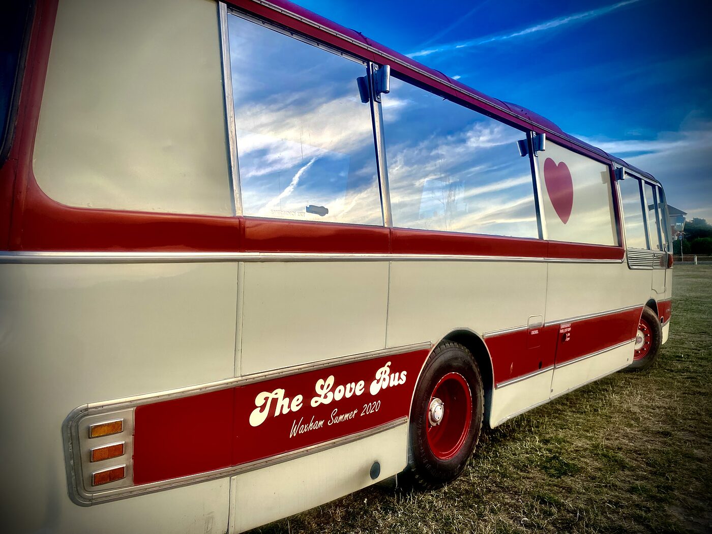Hand painted signwriting along the side of The Love Bus