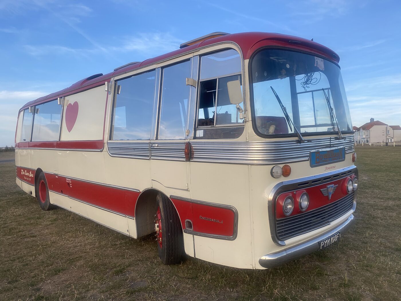 Three quarter view of The Love Bus in summer sunshine