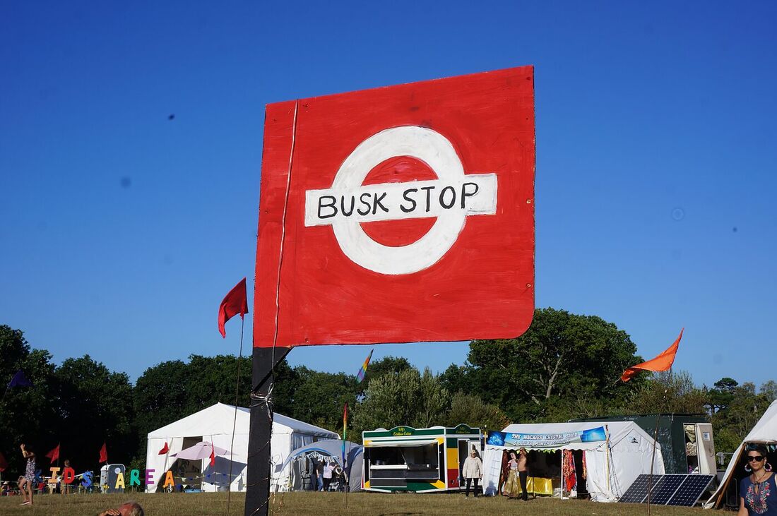 The Love Bus Busk Stop flag flying against a blue sky