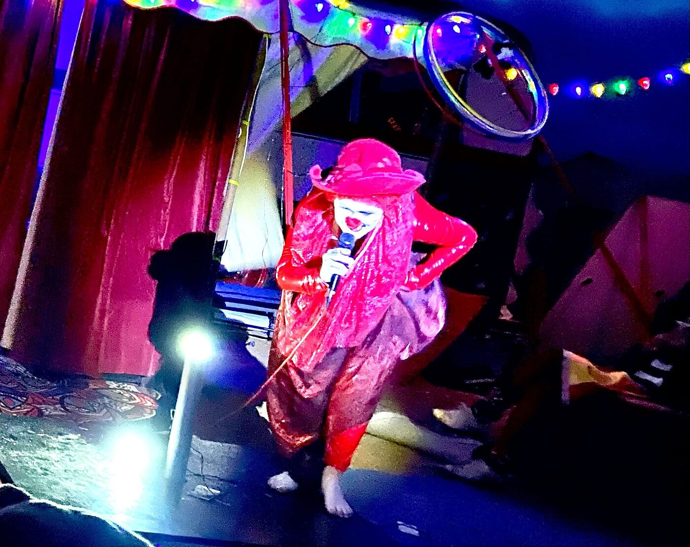 Cabaret clown performance beside The Love Bus at a festival
