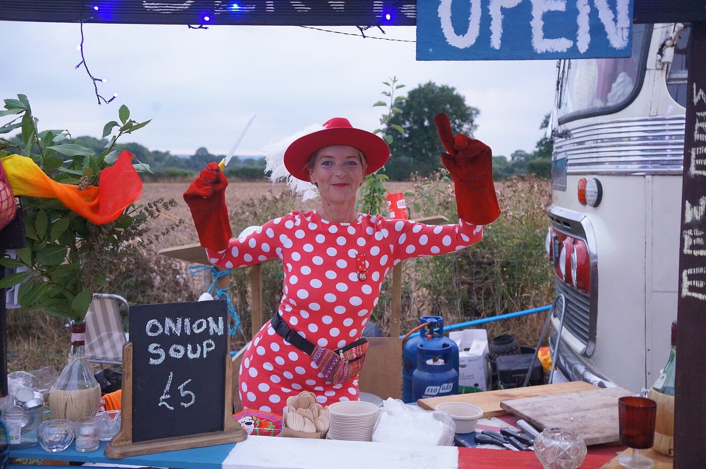 A cabaret performer beside The Love Bus