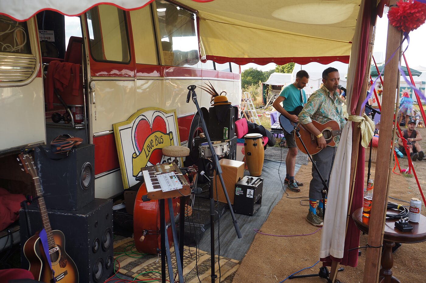 Guitars and amps set up on the Love Bus stage at Small World Festival