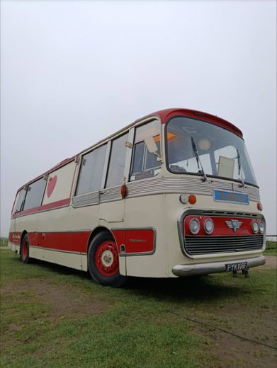 The Love Bus on grass from the front three quarter on an overcast day