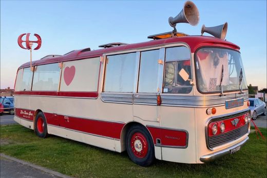 The Love Bus in golden evening light with its horn speakers and red heart