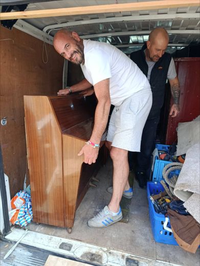 Moving the piano in a van before it was installed on The Love Bus
