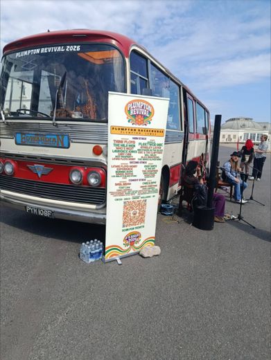 The Love Bus with a Plumpton Revival banner and musicians on the Worthing seafront