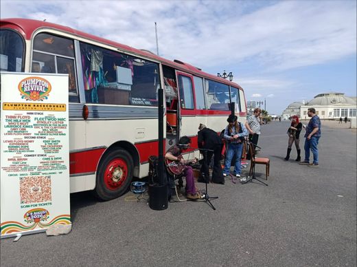 Buskers playing beside The Love Bus on the Worthing seafront during the Plumpton Revival media tour