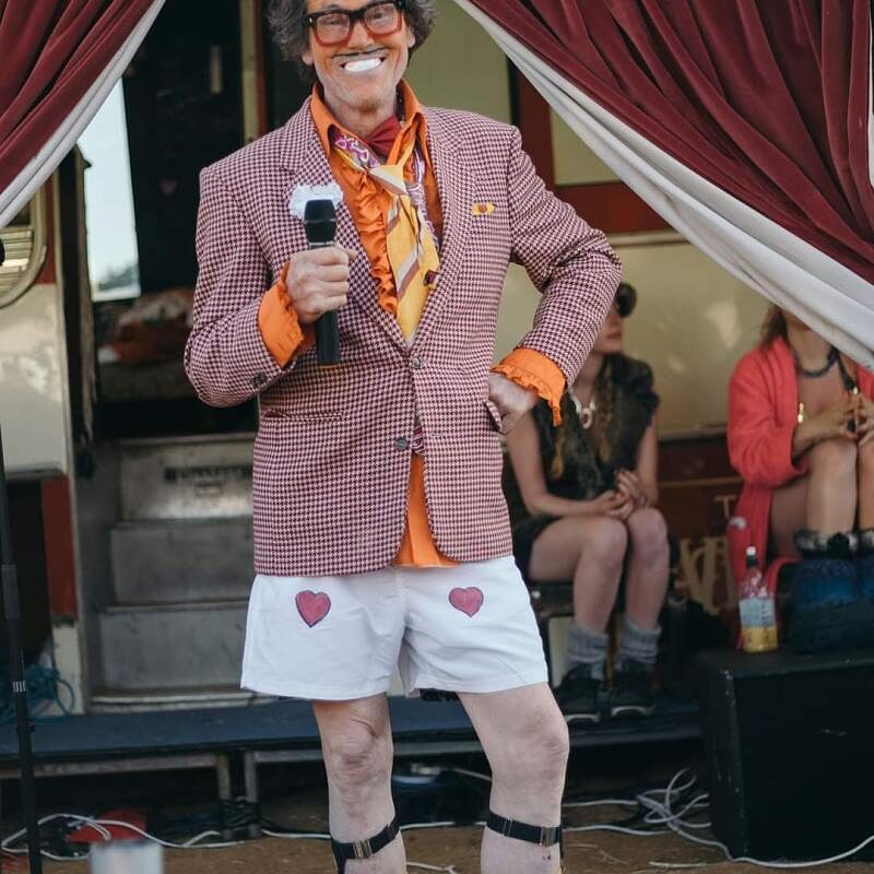 The Great Lorenzo performing to an audience beside the bus