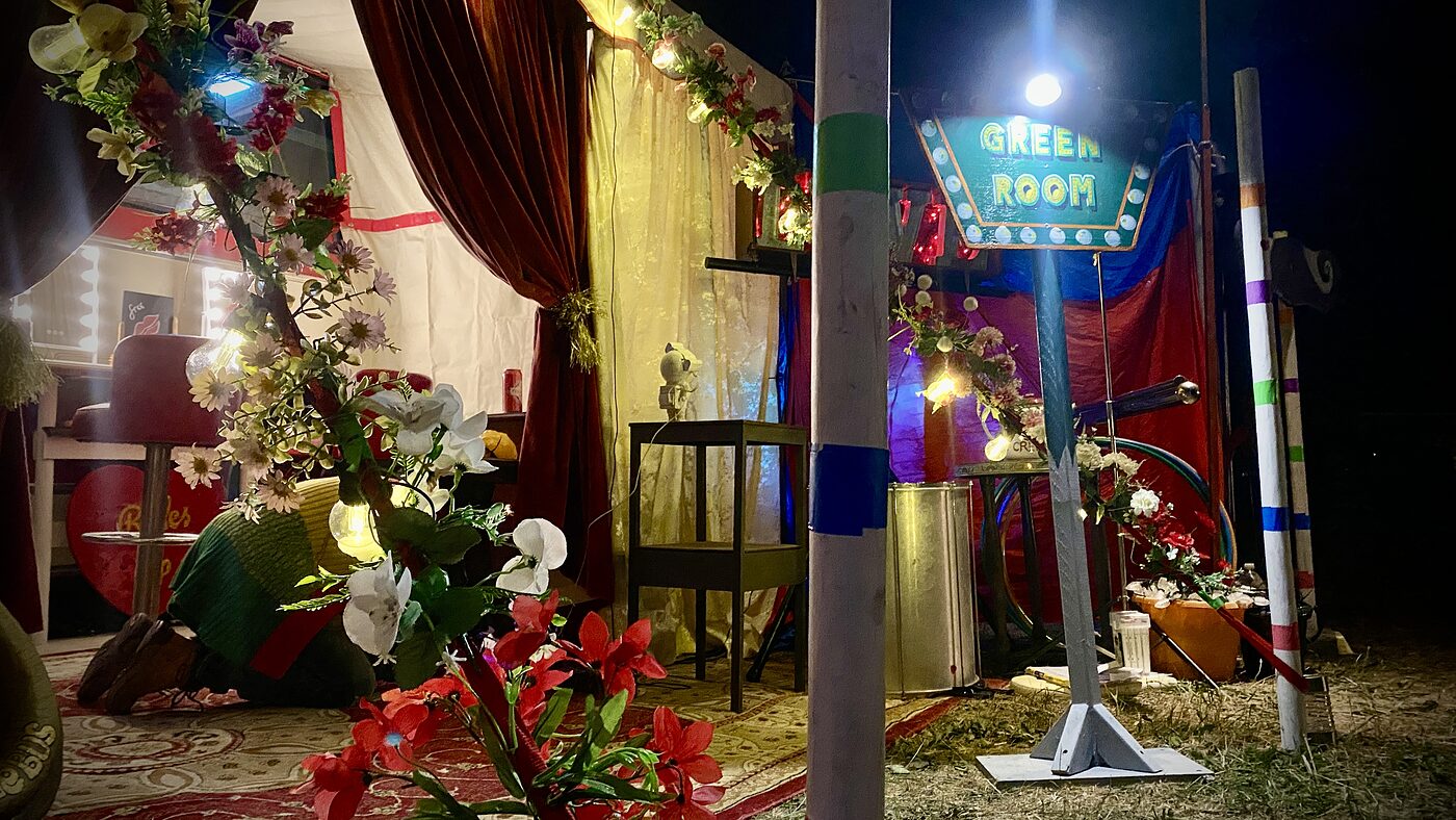 Floral dressed entrance to The Love Bus green room at night