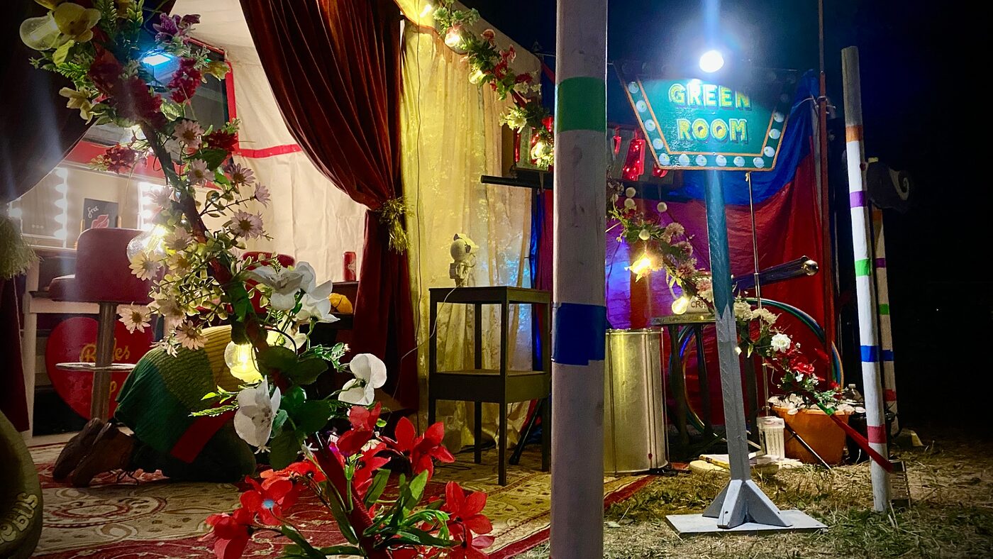 The Green Room neon sign at the entrance to The Love Bus