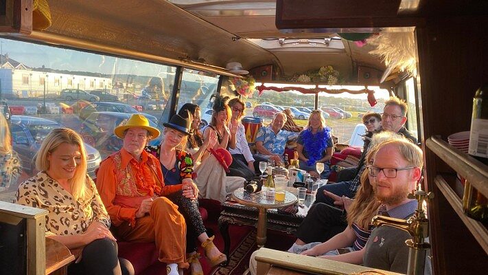 Guests seated around the table on board in daylight