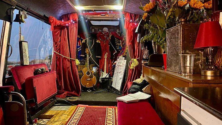 The Love Bus interior in the evening with guitars and the bar