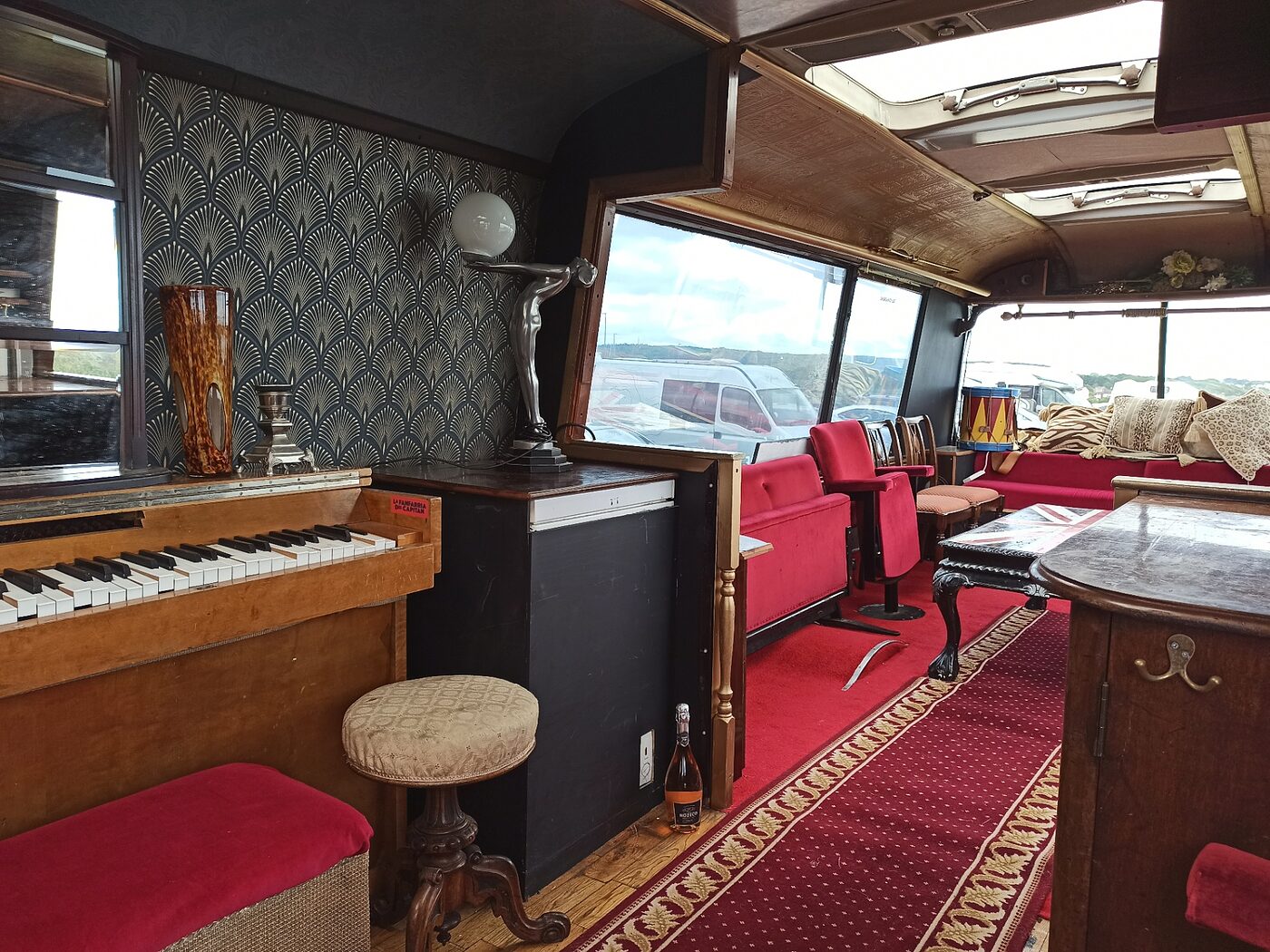 The Love Bus interior in daylight showing the piano and fit out