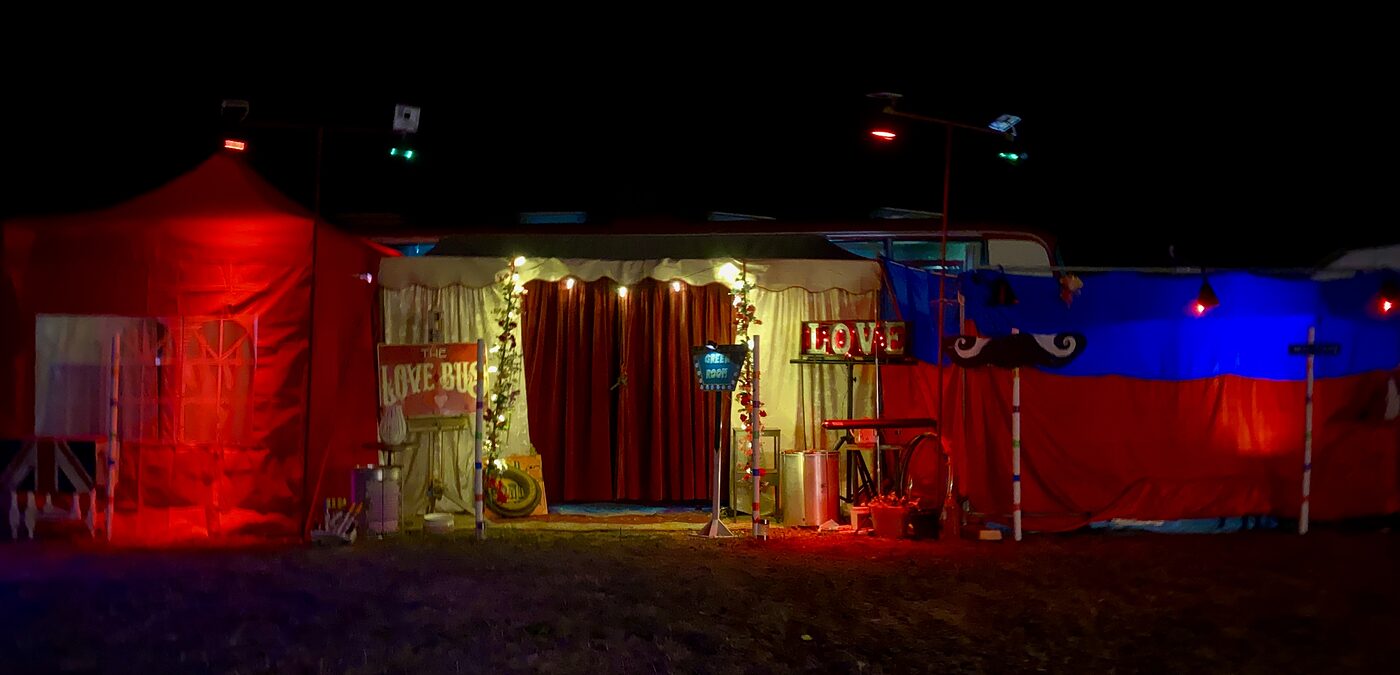 The Love Bus lit up at night