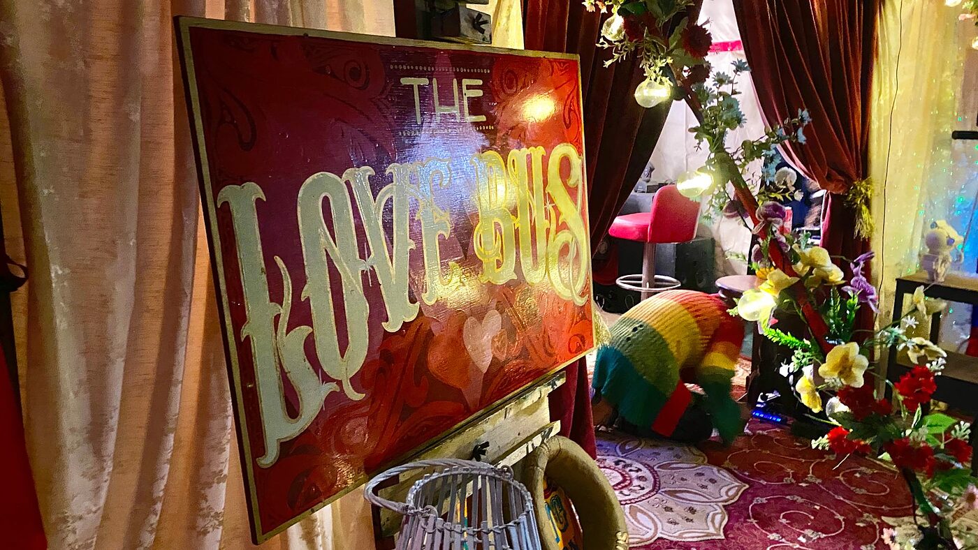 The illuminated Love Bus sign surrounded by decoration