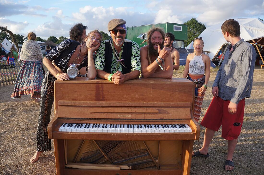 A piano played outside The Love Bus at sunset