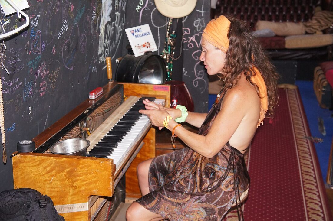 A performer playing the resident piano on board The Love Bus