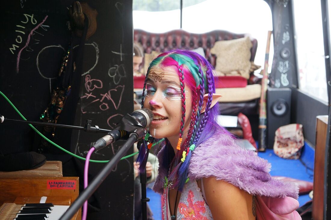 A singer at the microphone on board The Love Bus